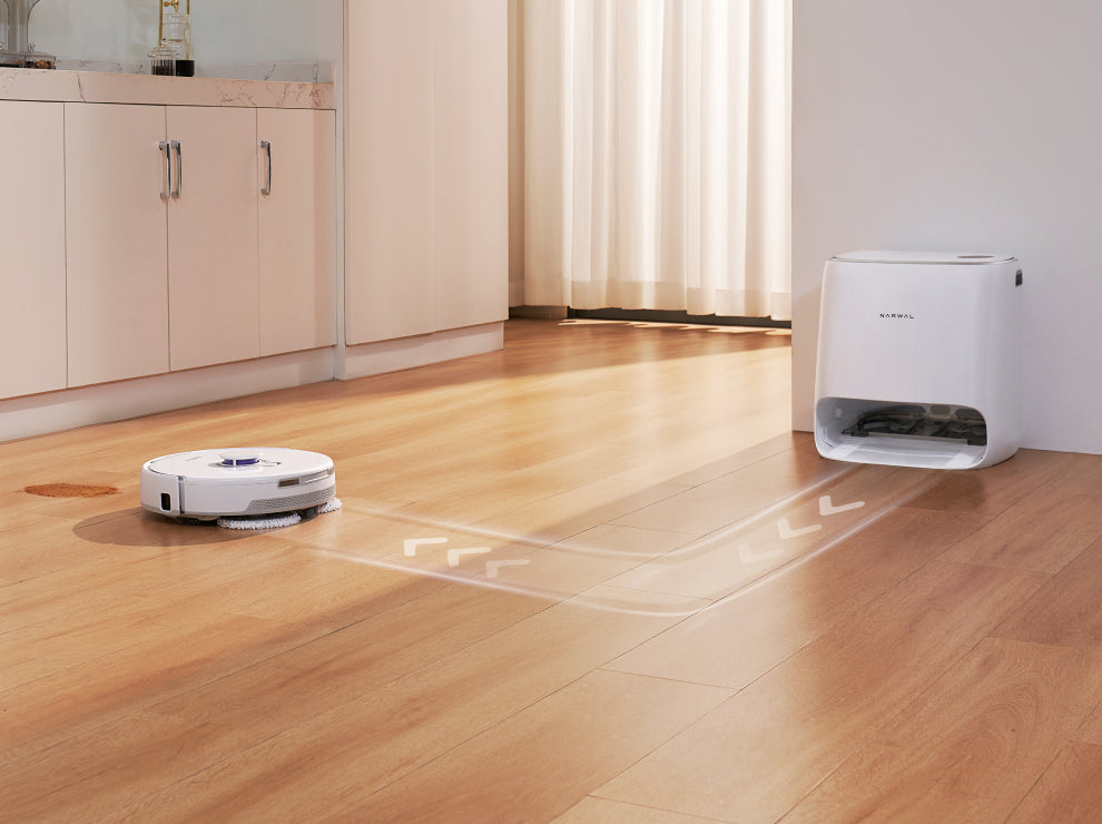 Narwal Freo X Ultra robot vacuum and mop cleaning a hardwood floor, following a smart navigation path with the charging dock in the background.